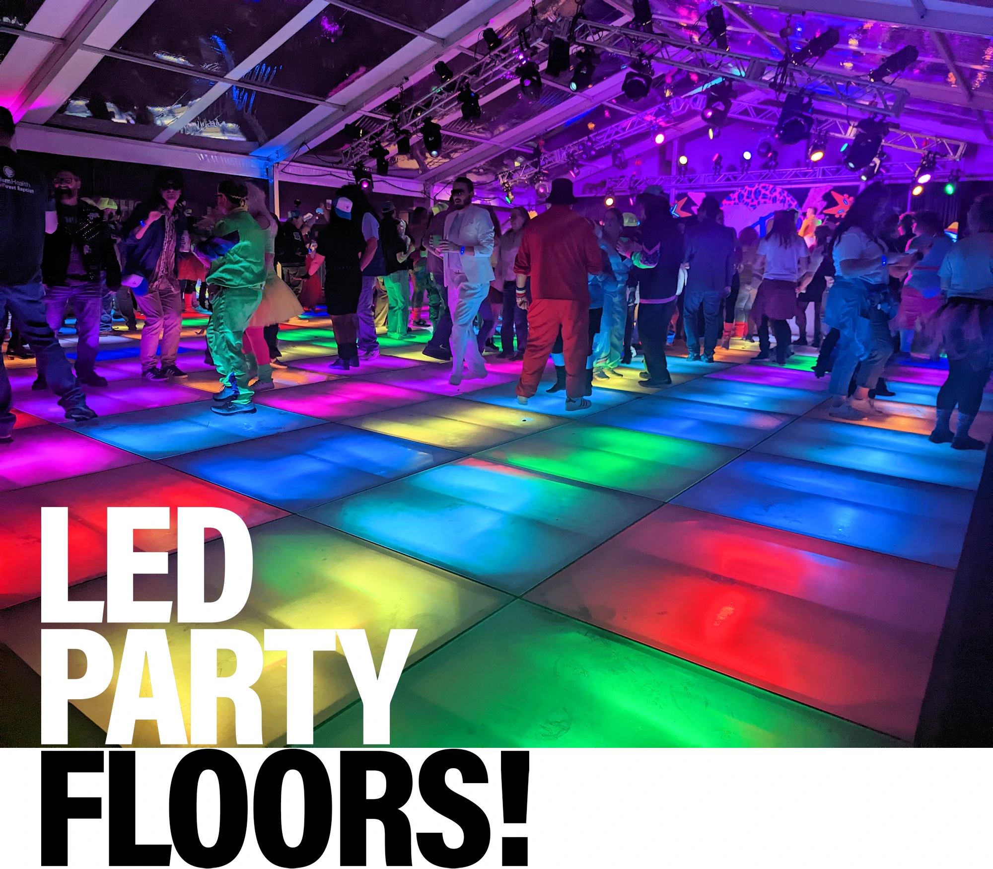 Raised platform, lighted dance floor in blue, green and yellow colors; with colored lights overhead.